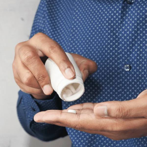 Man pouring sildenafil tablets